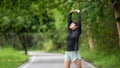 Healthy woman warming up stretching her arms. Asian runner woman workout before fitness and jogging Royalty Free Stock Photo