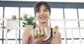 Healthy woman workout holding organic salad bowl healthy lifestyle. Wellness Asian women dressing organic green salad tomato Royalty Free Stock Photo