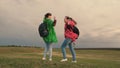 Healthy women tourists travel with backpacks in colorful raincoats. Slow motion. teamwork of travelers. Free girls