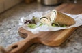 A healthy wrap with turkey, greens and cheese made