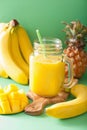 Healthy yellow smoothie with mango pineapple banana in mason jar Royalty Free Stock Photo