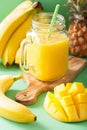Healthy yellow smoothie with mango pineapple banana in mason jar Royalty Free Stock Photo