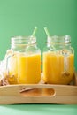 Healthy yellow smoothie with mango pineapple banana in mason jar Royalty Free Stock Photo