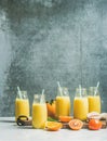 Healthy yellow smoothie over grey wall background, copy space
