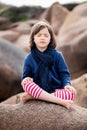 Healthy yoga child with eyes closed sitting in granite stone Royalty Free Stock Photo