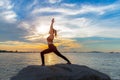 Healthy yoga woman lifestyle exercising vital meditate and energy yoga on the rock near the seashore, Royalty Free Stock Photo