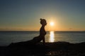 Healthy yoga woman meditation at sunrise seaside