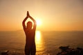 Healthy yoga woman meditation at sunrise seaside