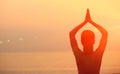 Healthy yoga woman meditation at sunrise seaside