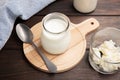 Healthy Yoghurt and kefir grains in glass on wooden table