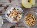 Healthy yogurt breakfast with apple and crushed cocoa beans