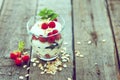 Healthy yogurt dessert with muesli, raspberries and black currants.