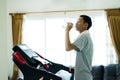 Healthy young asia man drinking water after finish exercise