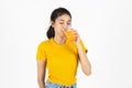 Healthy young Asian woman drinking orange juice over white isolated background. Lifestyle, Diet, Healthy and clean food concept Royalty Free Stock Photo