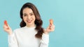 Healthy young Asian woman holding fresh tomato slice over blue isolated background. Healthy and beauty skin care concept Royalty Free Stock Photo