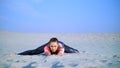 Healthy, young beautiful woman stretching, practicing yoga on the beach, at sunrise, Makes exercises for balance and Royalty Free Stock Photo