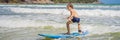 Healthy young boy learning to surf in the sea or ocean BANNER, LONG FORMAT Royalty Free Stock Photo