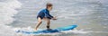 Healthy young boy learning to surf in the sea or ocean BANNER, LONG FORMAT Royalty Free Stock Photo