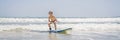 Healthy young boy learning to surf in the sea or ocean BANNER, LONG FORMAT Royalty Free Stock Photo