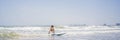 Healthy young boy learning to surf in the sea or ocean BANNER, LONG FORMAT Royalty Free Stock Photo