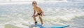 Healthy young boy learning to surf in the sea or ocean BANNER, LONG FORMAT Royalty Free Stock Photo