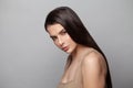 Healthy young brunette model woman with smooth straight hair and clear skin. Skincare, haircare and facial treatment concept