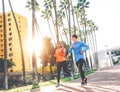 Healthy young couple jogging together at sunset time outdoor - People work out Royalty Free Stock Photo