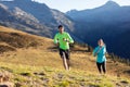 Healthy young couple running on mountain trail in the morning Royalty Free Stock Photo