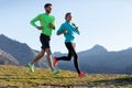 Healthy young couple running on mountain trail in the morning Royalty Free Stock Photo