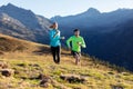 Healthy young couple running on mountain trail in the morning Royalty Free Stock Photo