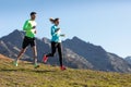 Healthy young couple running on mountain trail in the morning Royalty Free Stock Photo