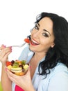 Healthy Young Fresh Faced Woman Eating a Colourful Exotic Fresh Fruit Salad Royalty Free Stock Photo