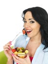 Healthy Young Fresh Faced Woman Eating a Colourful Exotic Fresh Fruit Salad Royalty Free Stock Photo