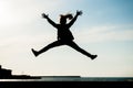 Healthy young teen girl jumping high in air in city with sea in summer outdoors Royalty Free Stock Photo