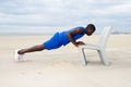 Healthy young man doing push ups on beach at the beach Royalty Free Stock Photo