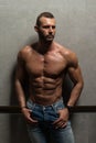 Portrait of Muscular Man Standing Near the Wall Royalty Free Stock Photo