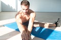 Healthy Young Man Stretches At The Floor Royalty Free Stock Photo