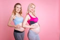 Healthy young mummies with baby bellies Royalty Free Stock Photo