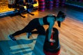 Healthy young woman in black sportswear using step platform at gym. Aerobic and fitness exercises. Royalty Free Stock Photo