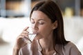 Healthy young woman drink pure mineral water