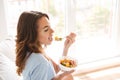 Healthy young woman eating healthy breakfast Royalty Free Stock Photo