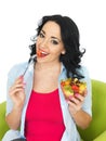 Healthy Young Woman Eating a Fresh Colourful Exotic Fruit Salad Royalty Free Stock Photo