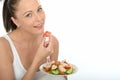 Healthy Young Woman Eating a Plate of Fresh Salmon Salad Royalty Free Stock Photo