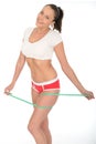 Healthy Young Woman with Green Tape Measure Around her Thighs Royalty Free Stock Photo