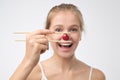 Healthy young woman holding one red cherry with sticks Royalty Free Stock Photo