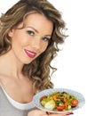 Healthy Young Woman Holding Plate of Mixed Colourful Healthy Salad