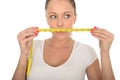 Healthy Young Woman Holding a Tape Measure Across Her Mouth Royalty Free Stock Photo