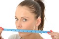 Healthy Young Woman Holding a Tape Measure Over Her Mouth Royalty Free Stock Photo