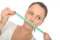 Healthy Young Woman Holding a Tape Measure Over Mouth Royalty Free Stock Photo