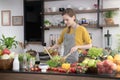 Healthy young woman in a kitchen preparing fruits and vegetables for healthy meal and salad Royalty Free Stock Photo